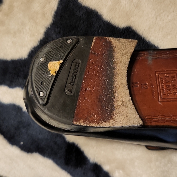 Men black leather loafers with tassles.
